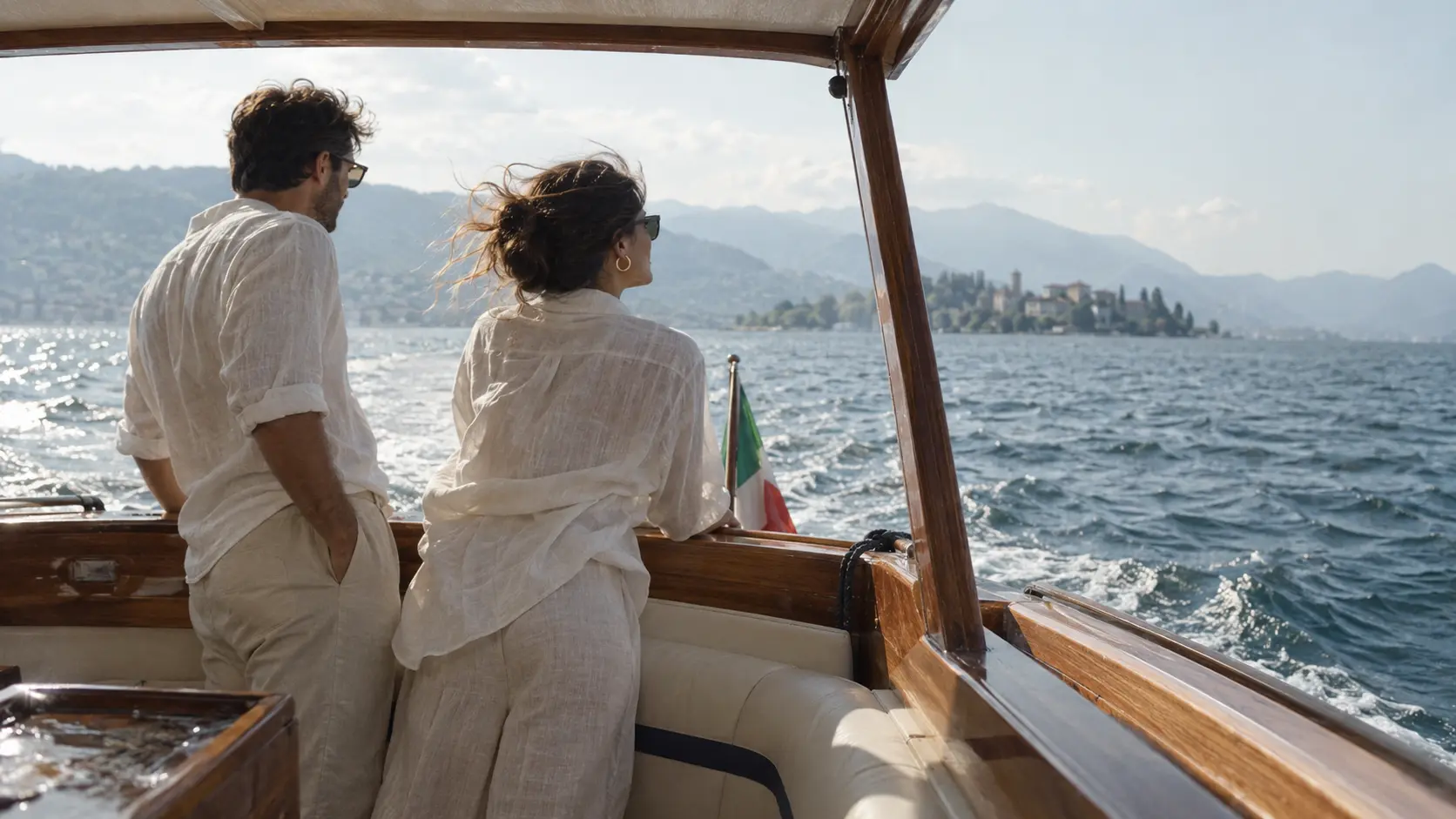 A couple travelling across an Italian lake